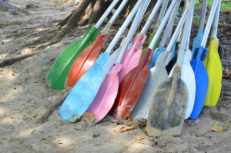 Pile of colorful kayak paddles at the  beachの写真素材