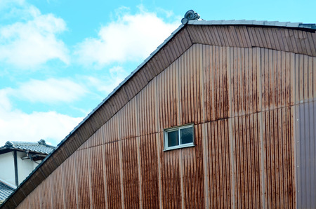 Rusted and grunge galvanized sheet house with window, architecture conceptの写真素材