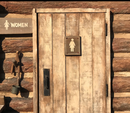 Woman rest room sign on grunge wooden doorの写真素材