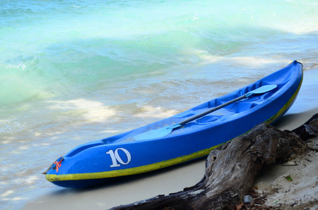 Blue kayak boat on the beach with blue seaの写真素材