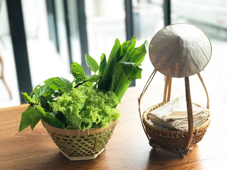 Fresh vegetable in woven bamboo basket in Vietnamese style restaurant