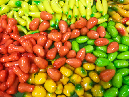 Traditional popular Thai dessert in colorful Deletable imitation fruits,Mung beans paste in fruit-shaped and coated with jelly,Fruit Shaped Mung Beans call Kanom Look Choup in Thai.の写真素材