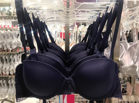 Blue bra hanging on rack in underwear storeの写真素材