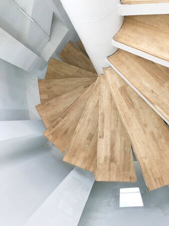 Wood spiral staircase with white wall, interior and architecture conceptの写真素材