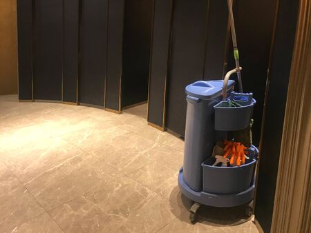 Blue cleaning tools service cart waiting for maid or cleaner in luxurious modern restroom of hotel or shopping mall or hospitalの写真素材