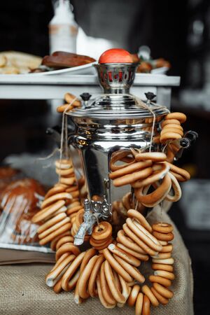 Fresh delicious bread rings (bagels, sushki or baranki) on a samovarの写真素材