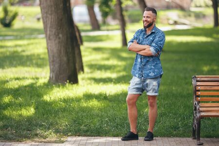 Young guy walking in the spring park. Sunny day. Vesna.Funny guy. A good mood. Walking portrait.の写真素材