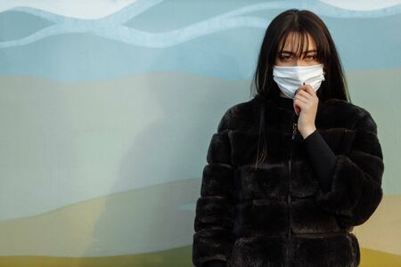 Beautiful Girl Wearing Medical Mask During Coronavirus COVID-19 Epidemic Pandemic Covid-19 coronavirus protection.の写真素材