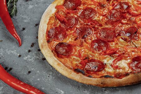 Thinly sliced pepperoni is a popular pizza topping in American-style pizzeriasの写真素材