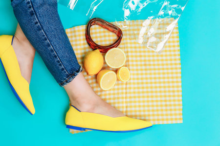 beautiful female legs are dressed in stylish yellow shoes without a heel. Light yellow summer...