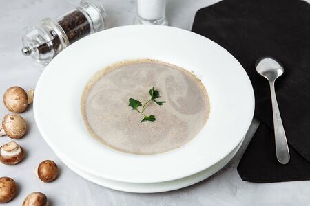 Mushroom soup with parsley on gray background, close up.の写真素材