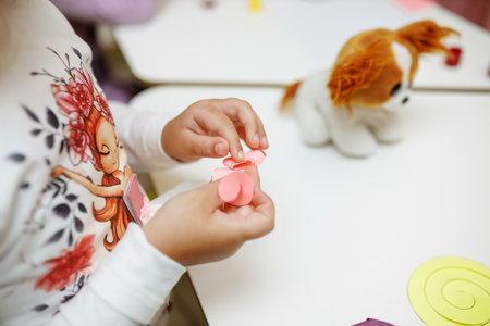 a child in training at home during quarantine makes origami out of paper. childrens creativity....