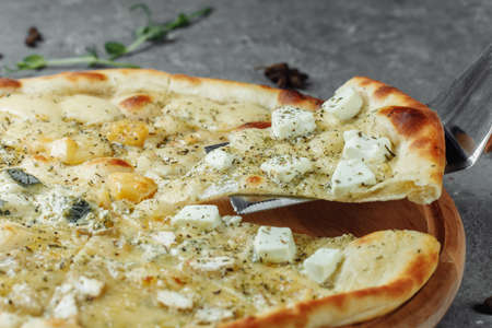 four cheese pizza, italian pizza. pizza stuffed with four varieties of cheese on a gray background.の写真素材