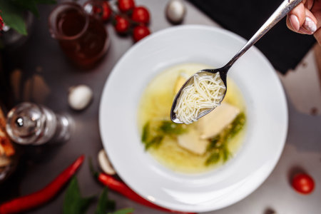 a white bowl filled with Delicious chicken noodle soup