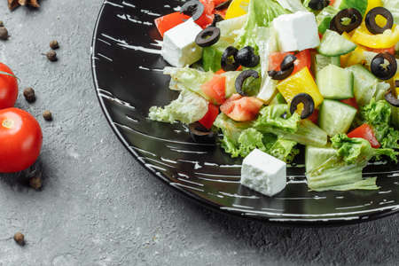 Greek Salad with Cucumeber, Kalamata Olives, Feta Cheese, Juicy Cherry Tomatoes and Fresh Basil. Home made food. Concept for a tasty and healthy vegetarian meal. Top view. Copy space.の写真素材