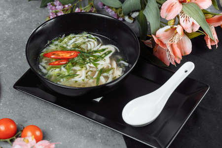 Bowl of chicken noodle on gray concrete background.の写真素材