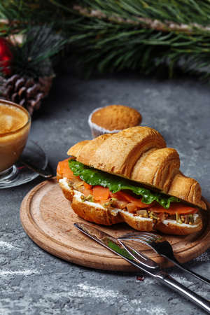 New Year's breakfast with croissants. New Year's croissant with red fish and avocado. New Year and Christmas concept.の写真素材