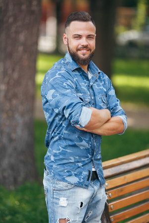 Young guy walking in the spring park. Sunny day. Vesna.Funny guy. A good mood. Walking portrait.