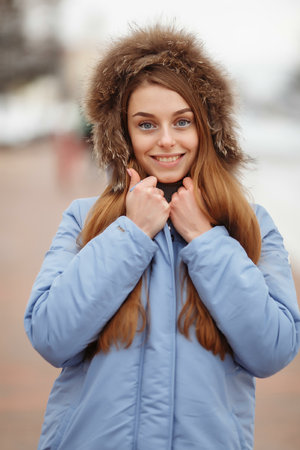 young woman are walking in the winter park. Winter park in the snow. Clothing advertising photo concept.の写真素材