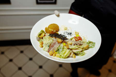 Caesar salad with chicken, cherry tomatoes, lettuce.の写真素材