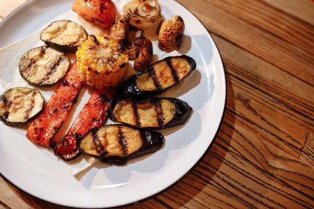 Tasty grilled vegetables on pan on dark background. Healthy food, summer food concept.の写真素材
