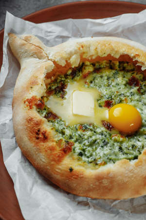 Some khachapuri traditional Georgian homemade cheese and spinach pies on the plateの写真素材