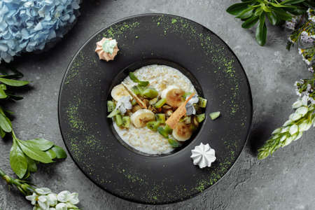 Quinoa porridge with banana, blueberry and pecan nuts for breakfastの写真素材