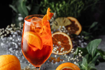 Aperol spritz cocktail on a gray concrete background. a glass of aperol spritz with orange slices. Summer cocktail in a glass.の写真素材