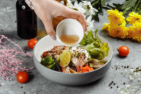 Healthy bowl - quinoa salad with tuna, broccoli, avocado on wooden rustic table. top view.の写真素材