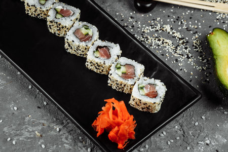 California roll sushi traditional Japanese rice food with salmon, avocado, cucumber, nori and sesame seeds.の写真素材