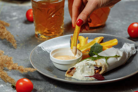 Shawarma Sandwich with French Fires and Salt Grinder on Dark Background.の写真素材