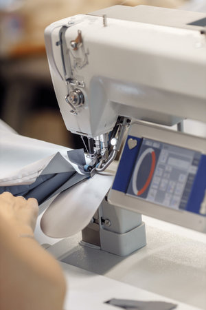 sewing machine scribbling fabric. tailoring at the factory.