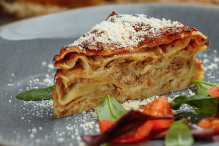 Homemade delicious Meat lasagna with basil leaf on the top. Close up. Recipe, menu. Italian cuisine. Side view.の写真素材