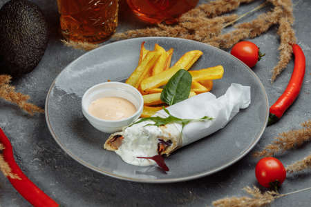 Shawarma Sandwich with French Fires and Salt Grinder on Dark Background.の写真素材