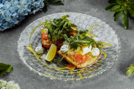 Eggs Benedict with avocado toast. Delicious and healthy breakfast. Healthy food concept.の写真素材