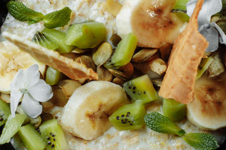 Quinoa porridge with banana, blueberry and pecan nuts for breakfast.の写真素材