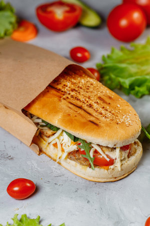 panini sandwich with crispy chicken and rucola saladの写真素材