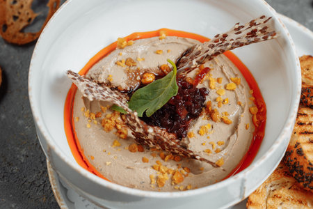 Mushroom cream soup on dark background. Champignon soup