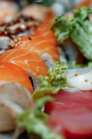 Mixed Sushi Set nigiri, rolls and sashimi served in traditional Japan black Sushioke round plate.の写真素材