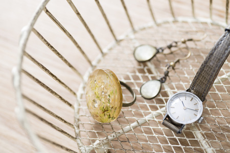 A clock, a ring, the pierced earrings which are contained in an accessory case の写真素材