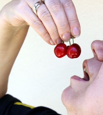 eating cherriesの写真素材