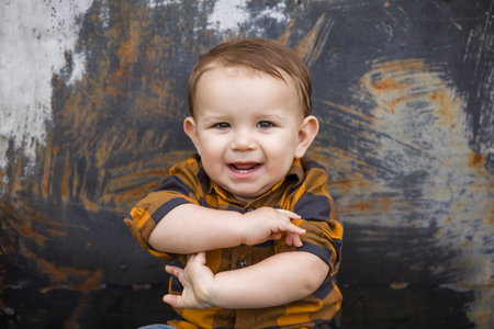 A baby boy eleven months old outdoors in the winter in a downtown setting.