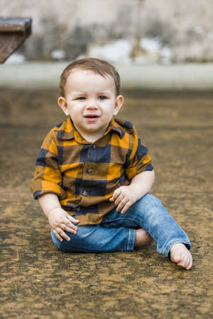 A baby boy eleven months old outdoors in the winter in a downtown setting.の写真素材