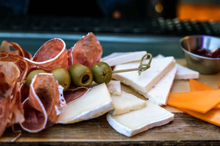 Meats, cheeses and olives on a charcuterie boardの写真素材