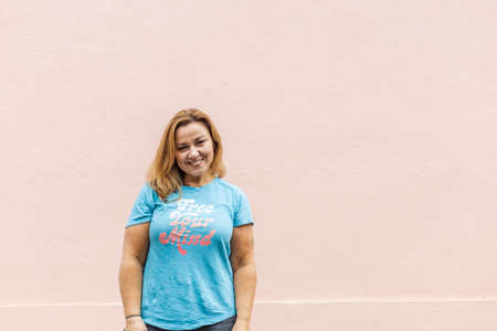 a waist up image of a woman in a free your mind t-shirt with jeansの写真素材