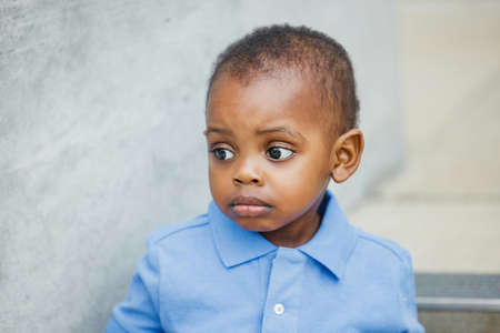Sad one year old toddler almost preschool age African-American boy with big eyes looking away with copy spaceの写真素材
