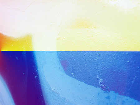 Closeup of colorful urban texture in Ukraine flag color - yellow and blue. Ukraine flag cairless paint shading with image of national flag. independence day banner.の写真素材