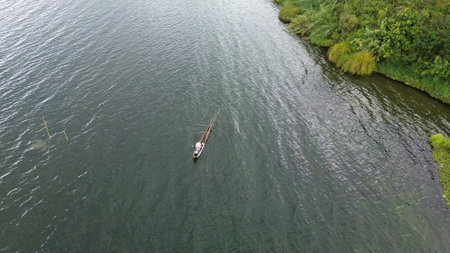 Aerial view of a fisherman in a boat on the river.の写真素材