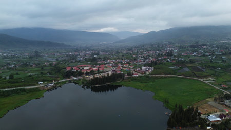 aerial view of the village and lake with cloudy sky in the morningの写真素材