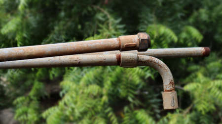 Old metal iron pipe one bended pipes another straight pipesの写真素材